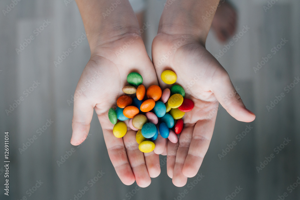 A child holding a handful of candy A child holding a handful of candy