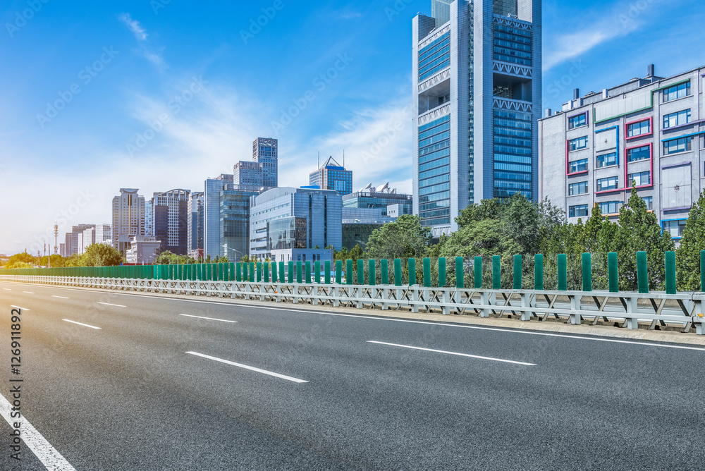 empty asphalt road through modern city in China. empty asphalt road through modern city in China.