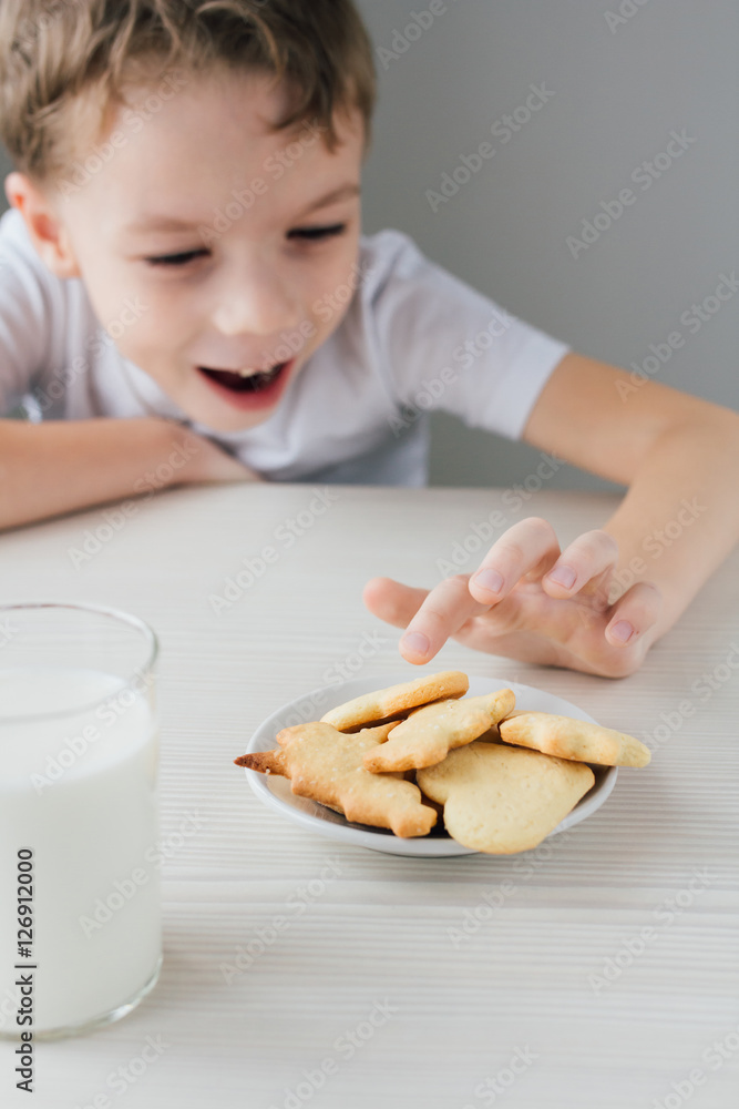 A child steals from a plate of freshly baked homemade cookies
