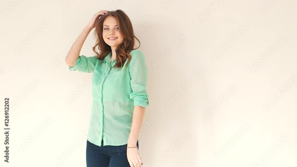 Young beautiful girl smiling at the camera, studio photo shoot, poses for the camera Young beautiful girl smiling at the camera, studio photo shoot, poses for the camera