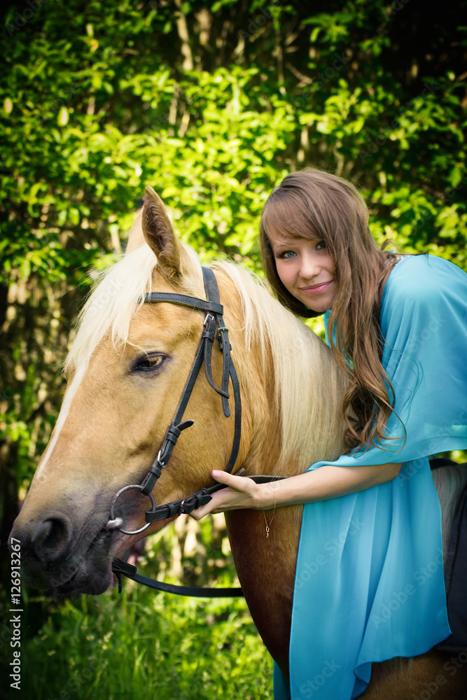 Fototapeta premium beautiful young girl with a horse 