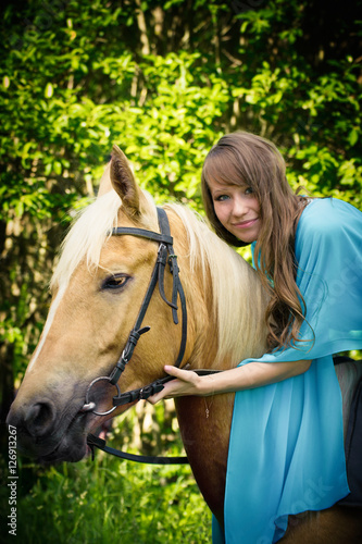 beautiful young girl with a horse 