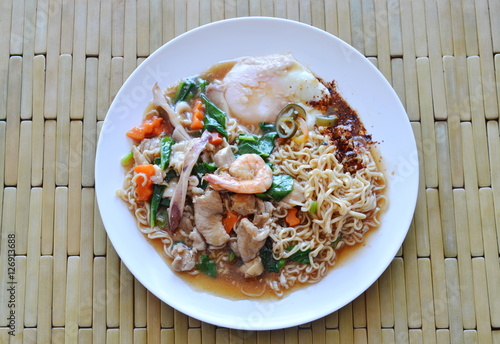 instant noodle dressing seafood gravy sauce and egg on dish