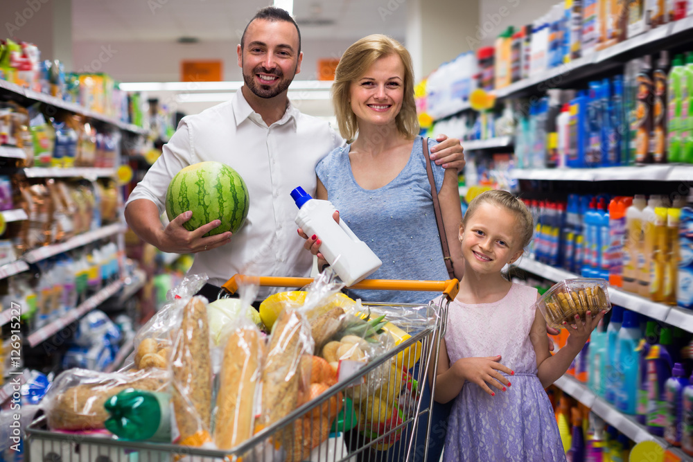 Parents with daughter shopping in hypermarket