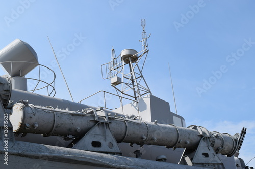 Part of the deck of a warship. communication devices and deck guns.
