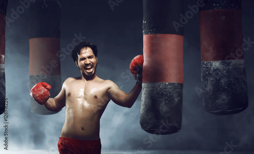 Powerful asian male boxer doing exercise