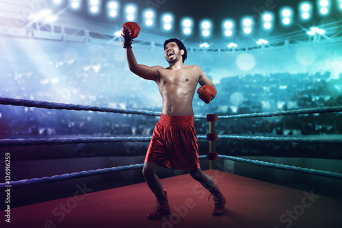 Принти на полотні Muscular asian male boxer throwing an uppercut