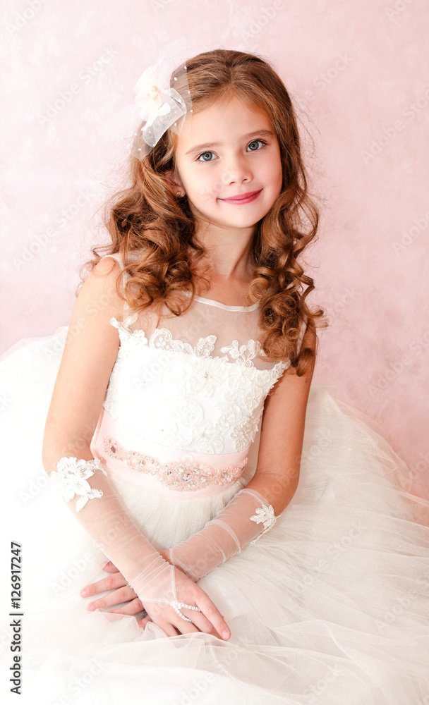 Adorable smiling little girl in white princess dress Adorable smiling little girl in white princess dress