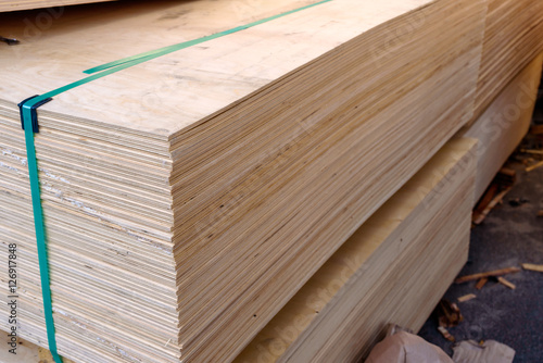 Фотография Sheets of stacked plywood in lumberyard