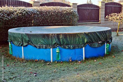 Garden pool in the winter covered with frost