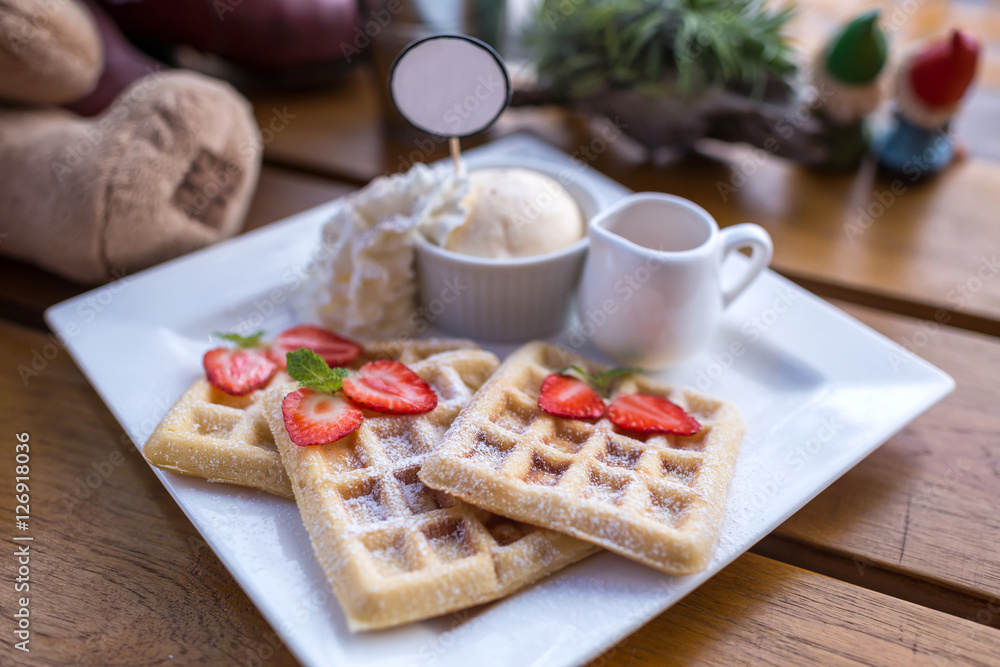 Strawberry waffle and honey with ice cream on wooden table. Strawberry waffle and honey with ice cream on wooden table.