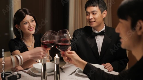 MS PAN Four people toasting during dinner party / China