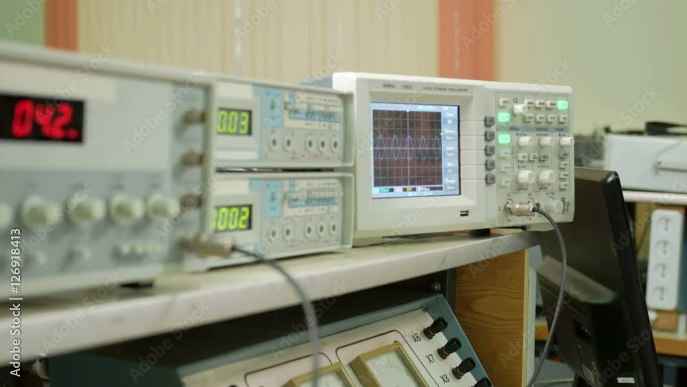 Equipment for measuring electrical signals is in the physical laboratory. The scoreboard lit instrumentation data. Oscilloscope and a pulse generator working together. Equipment for measuring electrical signals is in the physical laboratory. The scoreboard lit instrumentation data. Oscilloscope and a pulse generator working together.