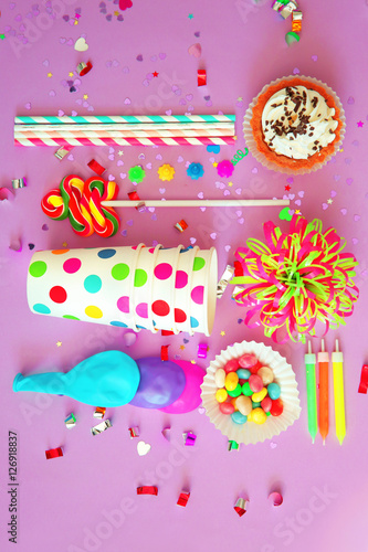 Birthday party objects on purple background  top view