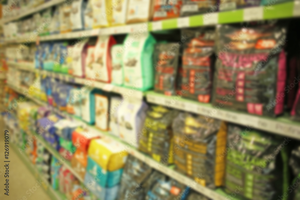 Packs of animal food on pet shop shelves