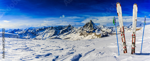 Fototapeta Ski Equipment with panoramic view of Matterhorn on a clear sunny