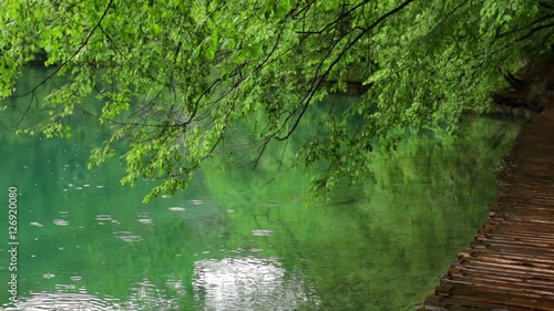 Rain drops falling in a blue lake in Plitvice lakes park. Croatia. 