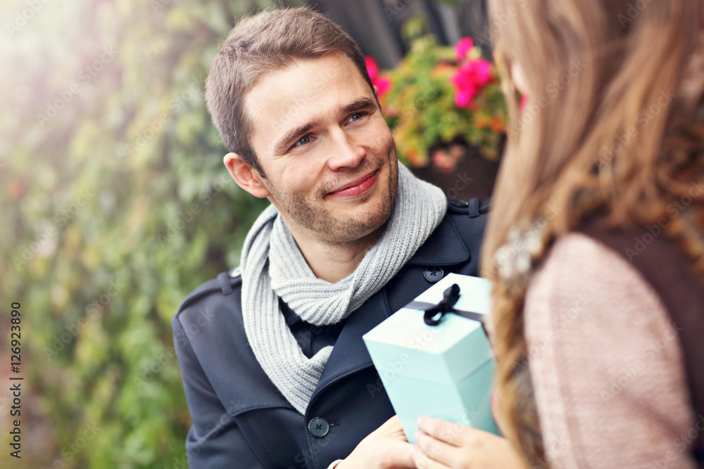 Fototapeta premium Young couple with present in the park