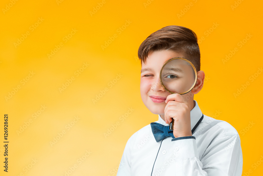 Little boy using magnifier looking close up Little boy using magnifier looking close up