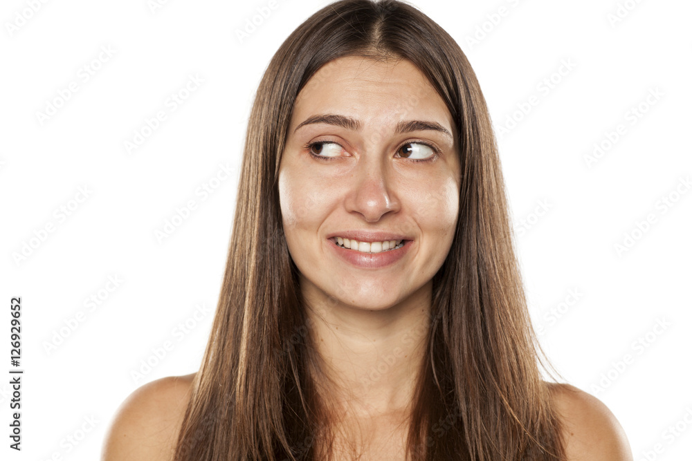 Beautiful young woman without makeup and false smile Beautiful young woman without makeup and false smile