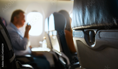 passanger in aircraft cabin. Interior passenger airliner cabin.