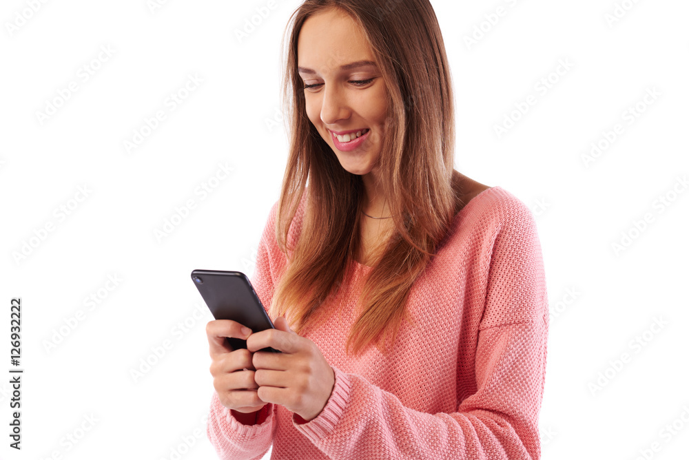 Trendy looking girl texting on smartphone standing turn side-on Trendy looking girl texting on smartphone standing turn side-on