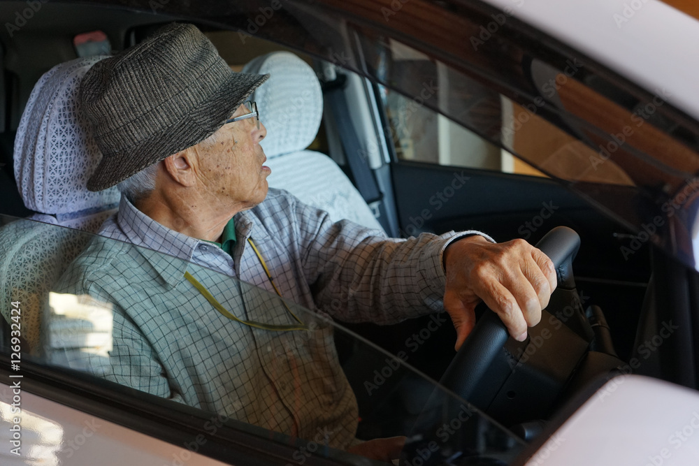Senior person driving a car Stock Photo | Adobe Stock