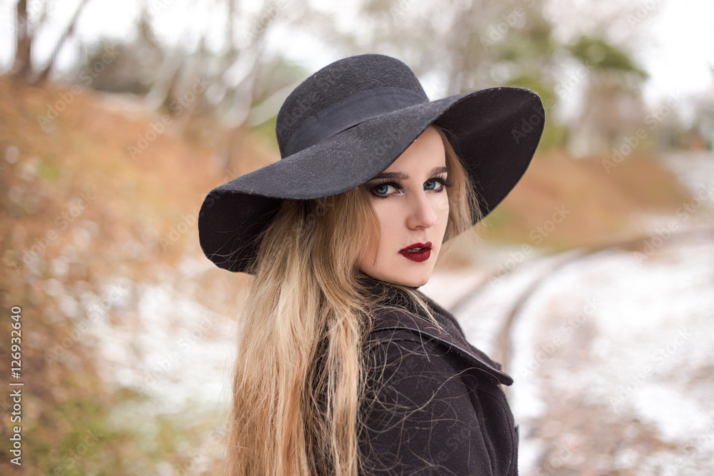 Portrait of a young beautiful woman in black hat retro style. Portrait of a young beautiful woman in black hat retro style.