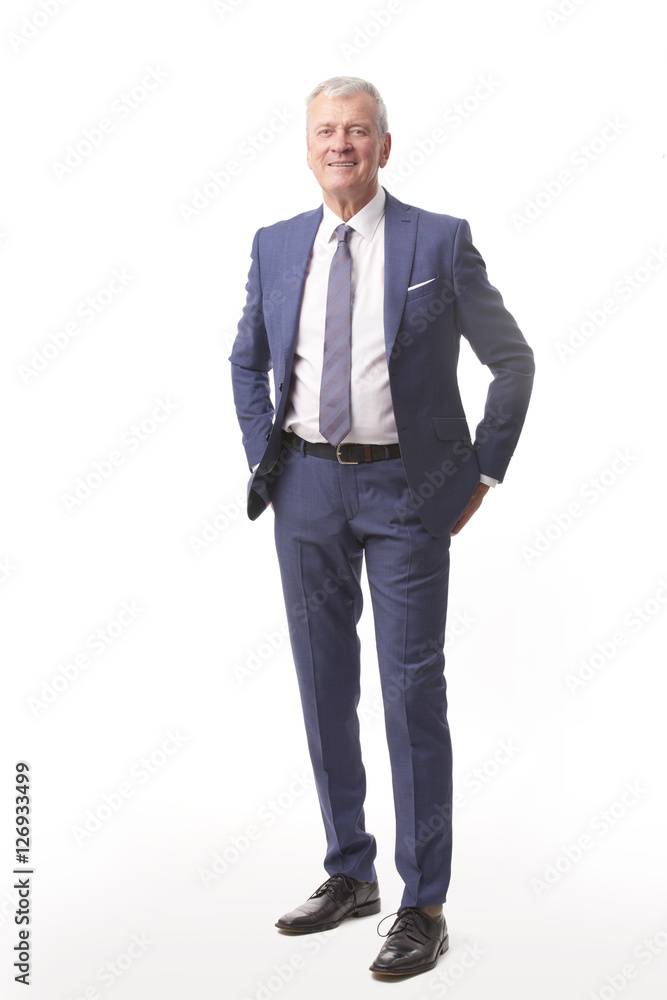 Executive businessman portrait. Full length shot of an professional senior man standing at white isolated background while looking at camera and smiling. Executive businessman portrait. Full length shot of an professional senior man standing at white isolated background while looking at camera and smiling.