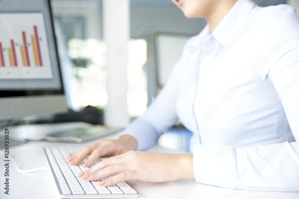 Typing on keyboard. Close-up image of a woman's hands typing on her computer keyboard while sitting at office and working online. Typing on keyboard. Close-up image of a woman's hands typing on her computer keyboard while sitting at office and working online.