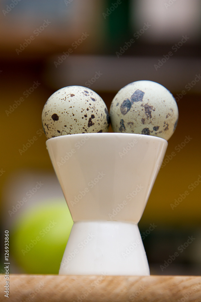 Two quail eggs in a white cup Two quail eggs in a white cup