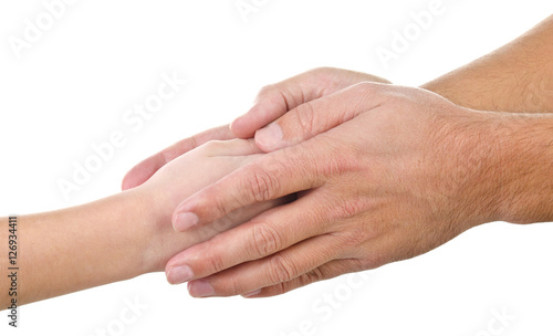 Small child's hand in the large palms of an adult