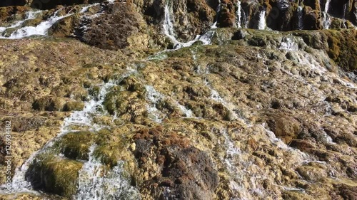 Waterfall stream at Huanglong Mountain with beautiful nature lime stone  in Sichuan , China on sunny day