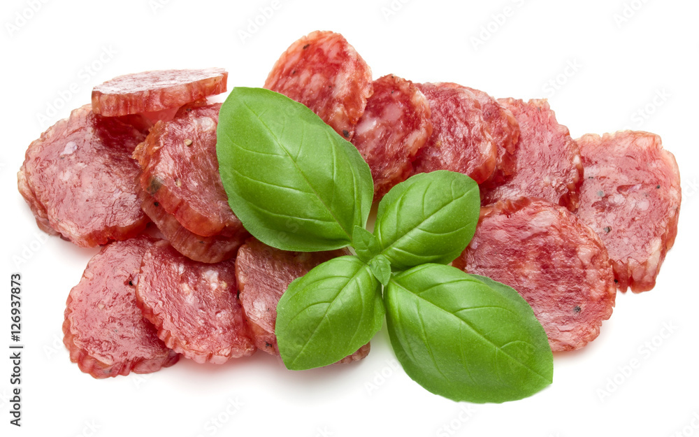 Salami smoked sausage slices and basil leaves isolated on white