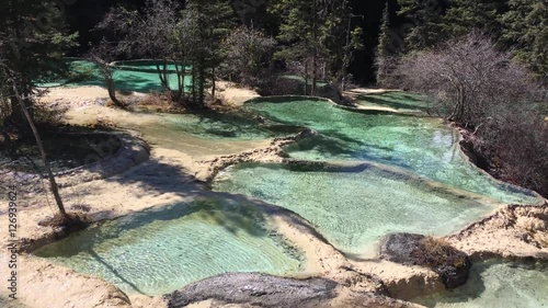 Huanglong Mountain with beautiful nature lime stone pond  ,waterfalls,lake  in Sichuan , China on sunny day