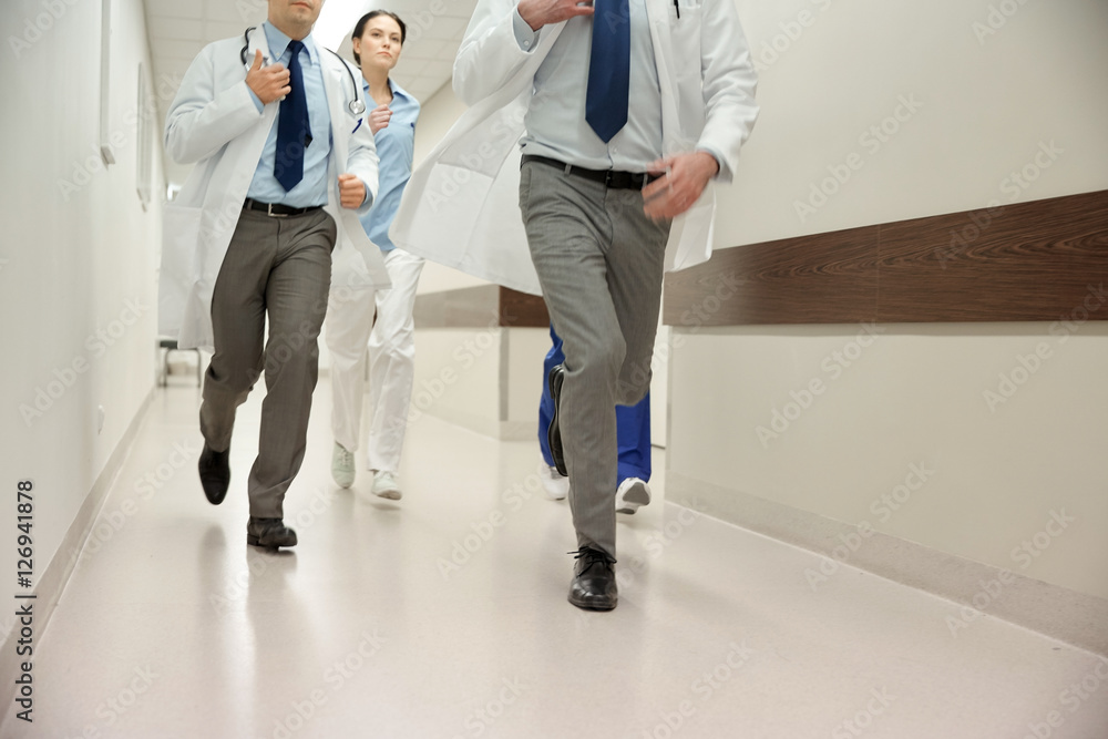 close up of medics or doctors running at hospital