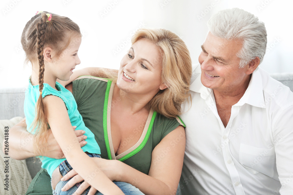 Grandparents with granddaughter on couch Grandparents with granddaughter on couch