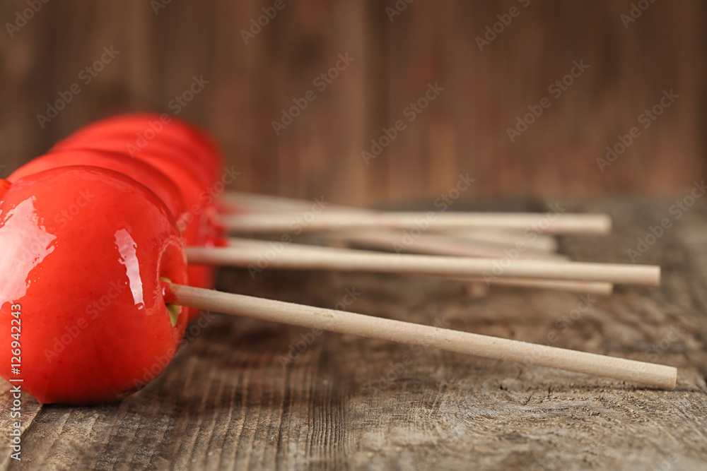 Delicious caramel apples on wooden background Delicious caramel apples on wooden background