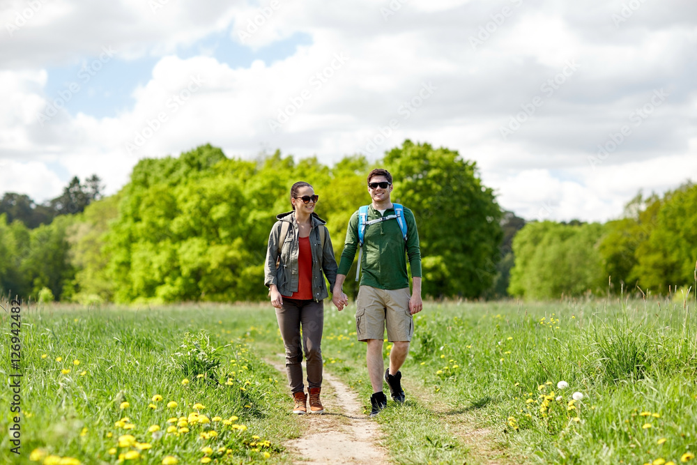 happy couple with backpacks hiking outdoors happy couple with backpacks hiking outdoors
