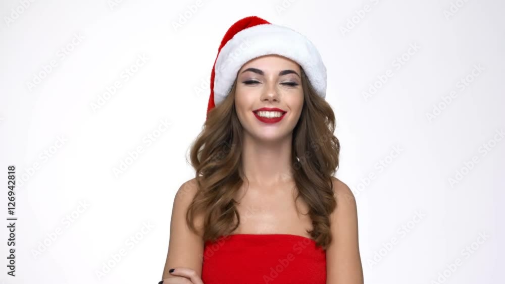 Happy cheerful woman in red santa claus outfit pops up and waving hand Happy cheerful woman in red santa claus outfit pops up and waving hand