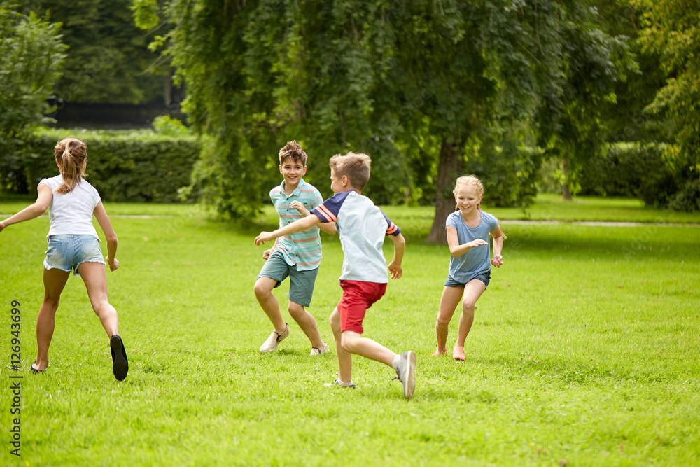 happy kids running and playing game outdoors happy kids running and playing game outdoors
