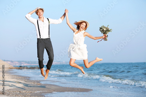 Young happy couple jumping ...