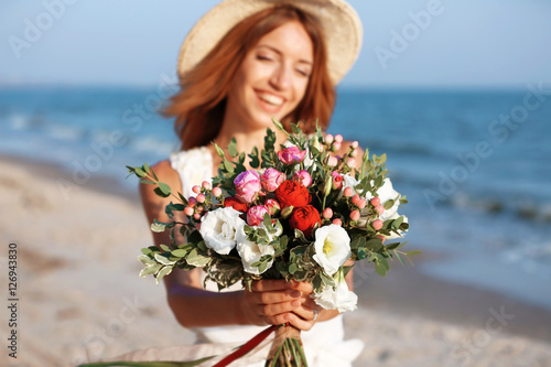 Happy woman with bouquet of...