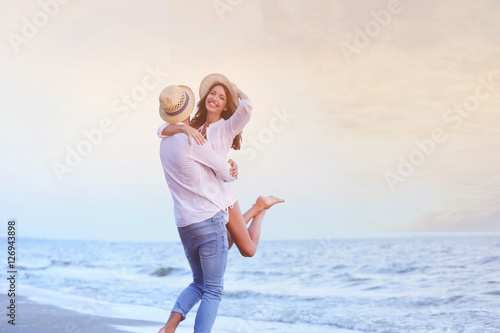 Young happy couple on seashore