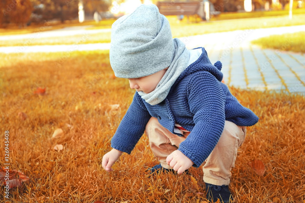 Cute little baby playing in green park Cute little baby playing in green park