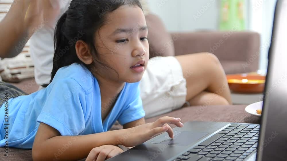 Close up shot of asian little girl using laptop computer at home with happiness
Close up shot of asian little girl using laptop computer at home with happiness