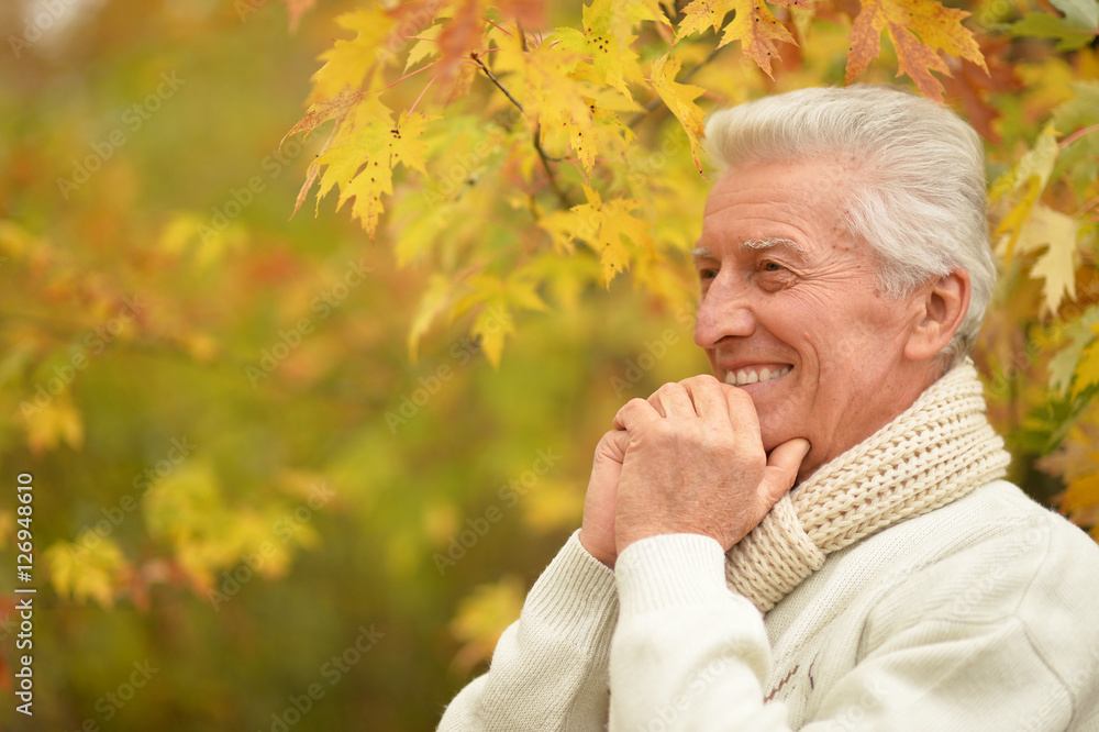 Smiling elderly man in autumn park Smiling elderly man in autumn park