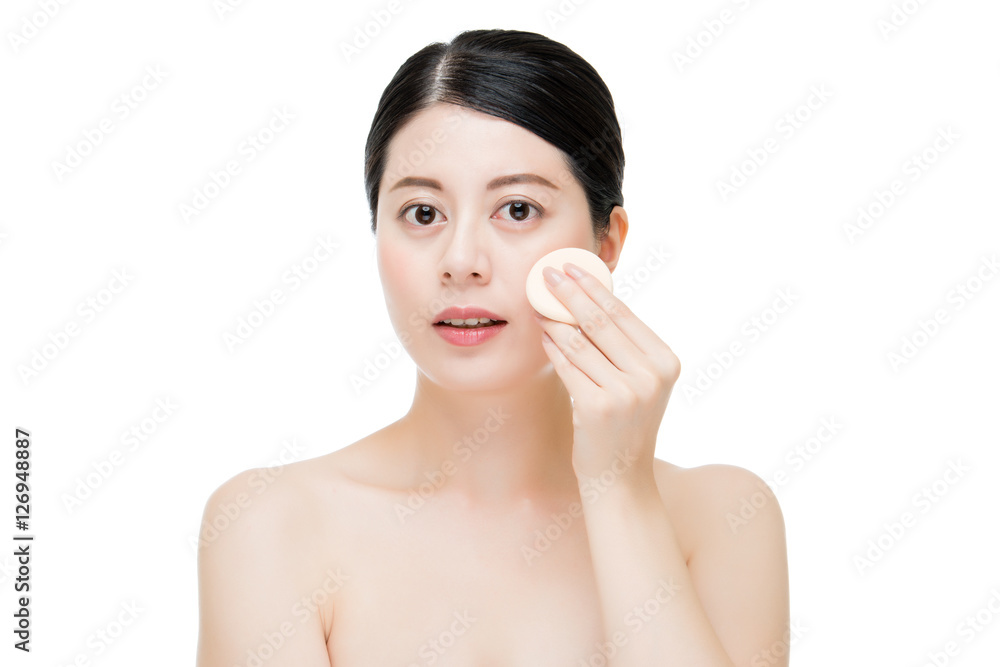 Beauty asian woman applying makeup with sponge powder puff Beauty asian woman applying makeup with sponge powder puff