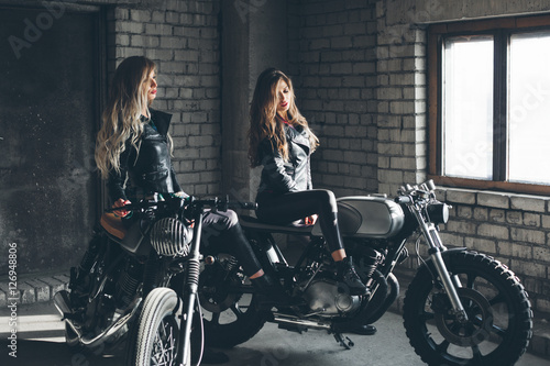 Bikers women in leather jackets with motorcycles