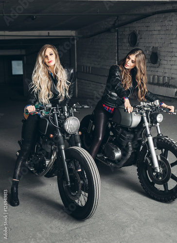 Bikers women in leather jackets with motorcycles